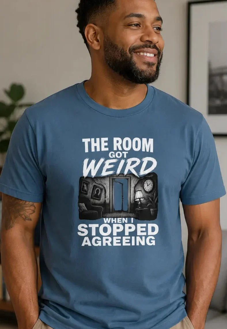 Man wearing a blue t-shirt with the text 'the room got weird when i stopped agreeing'