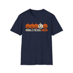 Navy Graphic T-shirt design featuring five jack-o’-lanterns, with one white mismatched pumpkin standing out from four orange pumpkins, above the words “Normal Is the Real Horror.”