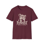 A maroon short-sleeve crewneck t-shirt featuring a cream graphic of a lioness head with the text 'FEMINIST FOR ALL ANIMALS' printed on the front, displayed against a solid white background.