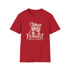 A red short-sleeve crewneck t-shirt featuring a white graphic print of a lioness head with the text 'FEMINIST FOR ALL ANIMALS' printed below it, displayed on a solid white background.