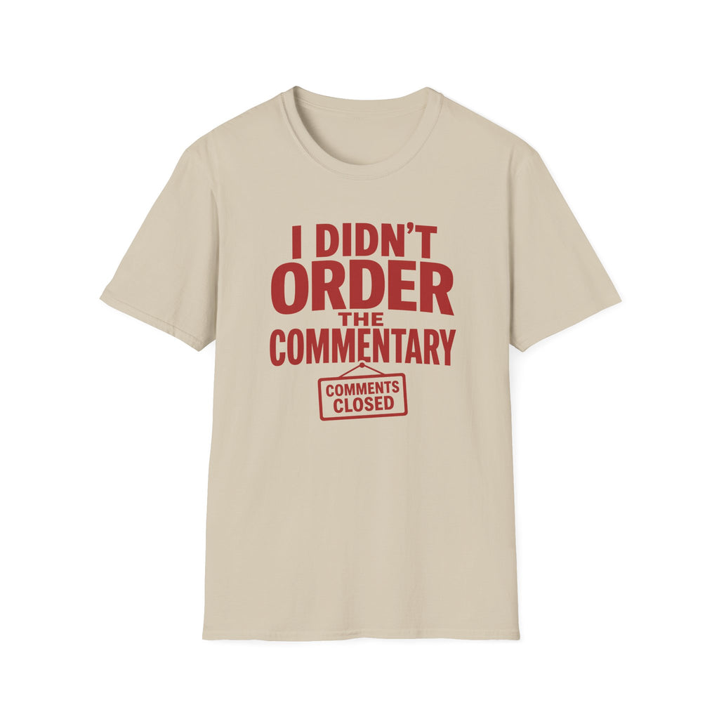 A beige crewneck t-shirt with a bold red graphic print on the front that reads 'I DIDN'T ORDER THE COMMENTARY' and a 'COMMENTS CLOSED' stamp graphic below it, shown against a plain white background.