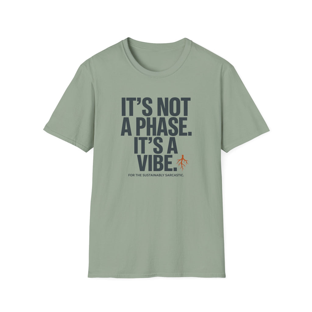 A sage green crewneck t-shirt with a dark gray text graphic reading 'IT'S NOT A PHASE. IT'S A VIBE' and a small orange stick figure icon, displayed on a clean white background.