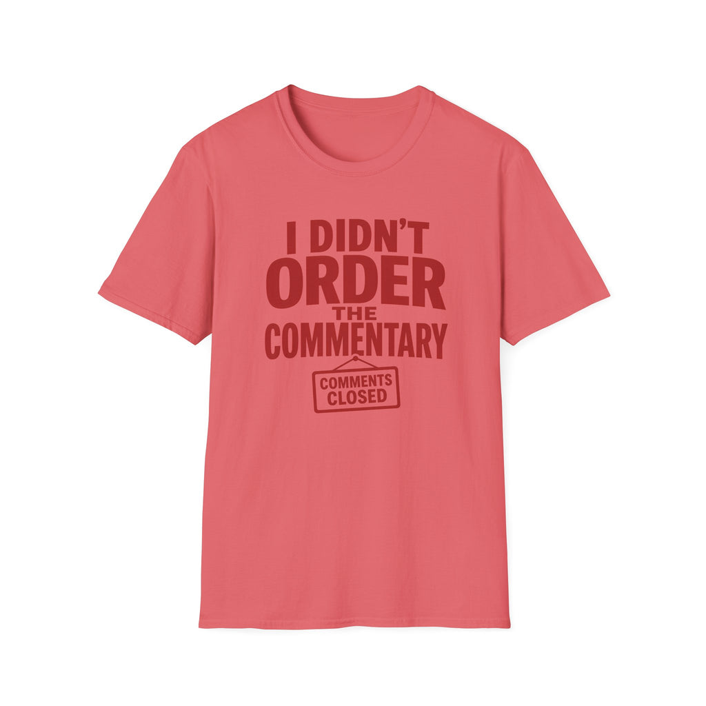 A coral pink short-sleeve t-shirt with a dark red graphic text print reading 'I DIDN'T ORDER THE COMMENTARY' and a 'COMMENTS CLOSED' stamp graphic, shown on a plain white background.