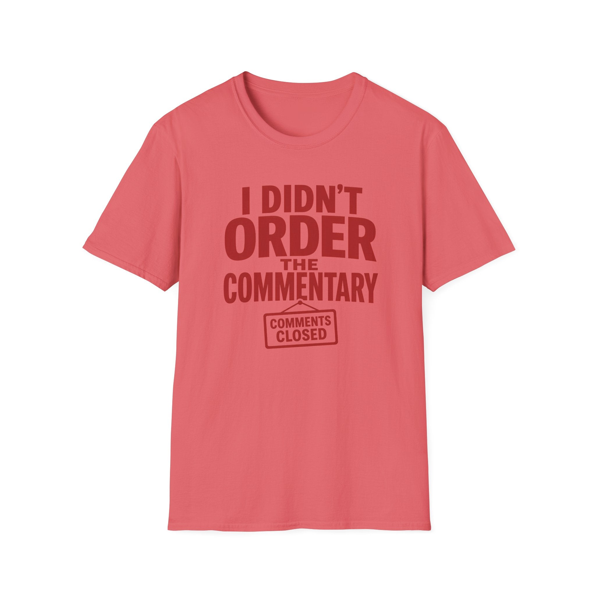 A coral pink short-sleeve t-shirt with a dark red graphic text print reading 'I DIDN'T ORDER THE COMMENTARY' and a 'COMMENTS CLOSED' stamp graphic, shown on a plain white background.