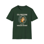 Forest green short-sleeve t-shirt with a graphic of a cartoon beaver running inside a large exercise wheel, accompanied by the text 'STILL PROCESSING THE LAST RIDICULOUS STATEMENT'.