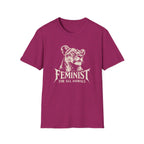 A heather magenta short-sleeve t-shirt with a distressed white graphic of a lioness head and the text 'FEMINIST FOR ALL ANIMALS' printed on the chest, shown against a plain white background.