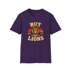 A purple short-sleeve crewneck t-shirt featuring a retro-style graphic of a male lion's face over a sunset, with the words 'BUT LIONS' printed in a distressed beige font.