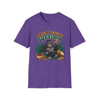 A heather purple short-sleeve t-shirt with a graphic of a gorilla holding a banana next to a bowl of protein powder, with the text 'PROTEIN DEFICITY SURVIVOR' above it, shown on a plain white background.