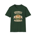 Dark green graphic t-shirt with an image of a tub of hummus and text 'emotionally supported by hummus' on a wooden board with jeans and sneakers