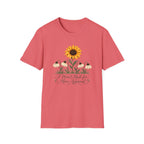 Coral pink graphic T-shirt featuring a bright yellow sunflower above four drooping cream flowers with I Wasn't Made for Mass Approval in cursive text.