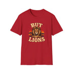 A red short-sleeve crewneck t-shirt featuring a graphic print of a lion's face with the text 'BUT LIONS' in a retro beige font, set against a plain white background.