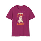 Pink graphic T-shirt design featuring an unimpressed cream ghost with crossed arms and the words “I Said Boo I Meant Leave” in cream and orange lettering.