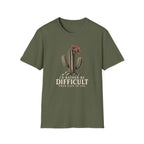 Military green short-sleeve crewneck t-shirt featuring a graphic of a cactus with a flower and the text 'I'D RATHER BE DIFFICULT THAN EASY TO USE' printed on the front, displayed against a solid white background.