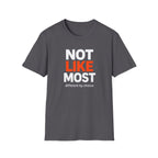 A dark gray crewneck t-shirt with a graphic text print reading 'NOT LIKE MOST' in white and orange, and 'different by choice' in smaller white text below, shown on a plain white background.