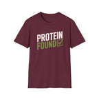 A maroon short-sleeve crewneck t-shirt with a graphic on the chest reading 'PROTEIN FOUND' in white and olive green, with a green checkmark, shown on a plain white background.