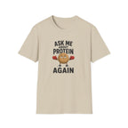 Sand t-shirt with cartoon graphic and text 'ask me about protein again'