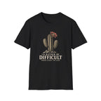 Black short-sleeve crewneck t-shirt featuring a graphic of a cactus with a flower and the text 'I'D RATHER BE DIFFICULT THAN EASY TO USE' printed on the front, displayed against a solid white background.