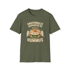 military green graphic t-shirt with an image of a tub of hummus and text 'emotionally supported by hummus' on a wooden board with jeans and sneakers