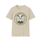 A beige short-sleeve crewneck t-shirt featuring a circular graphic print of a black and white cow inside a badge design with the text 'FOR THE RIGHTFUL OWNER' and 'NOT YOUR BOTTLE' and 'RESERVED'.