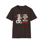 A brown short-sleeve crewneck t-shirt featuring a graphic of a cartoon cow with crossed arms next to the text 'YOU DRINK MY MILK? WEIRD.' in cream and red lettering, shown on a plain white background.
