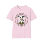 A light pink short-sleeve crewneck t-shirt featuring a circular graphic print of a black and white cow with a bell and the text 'FOR THE RIGHTFUL OWNER NOT YOUR BOTTLE' and 'RESERVED'.