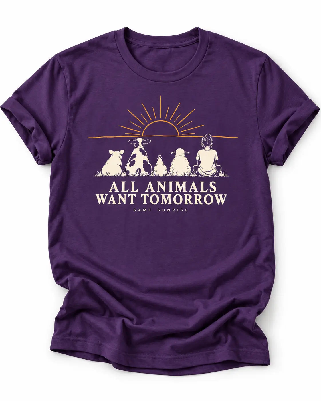 Purple graphic T-shirt featuring a pig, cow, chicken, sheep and person sitting beneath a sunrise with the words “All Animals Want Tomorrow” and “Same Sunrise.”