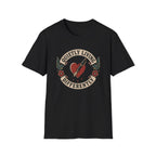 Traditional tattoo-inspired design featuring a heart pierced by a fountain pen with the words "Quietly Living Differently."