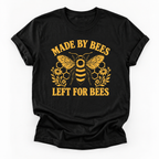 A black short-sleeve crewneck t-shirt with a yellow graphic print featuring a bee, honeycomb, flowers, and the text 'MADE BY BEES LEFT FOR BEES' on a white background.
