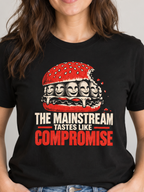 A woman wearing a black graphic t-shirt with a cartoon sandwich design and the text 'THE MAINSTREAM THINGS LIKE COMPROMISE'. She is standing in a brightly lit room with a plant and framed wall art in the background.