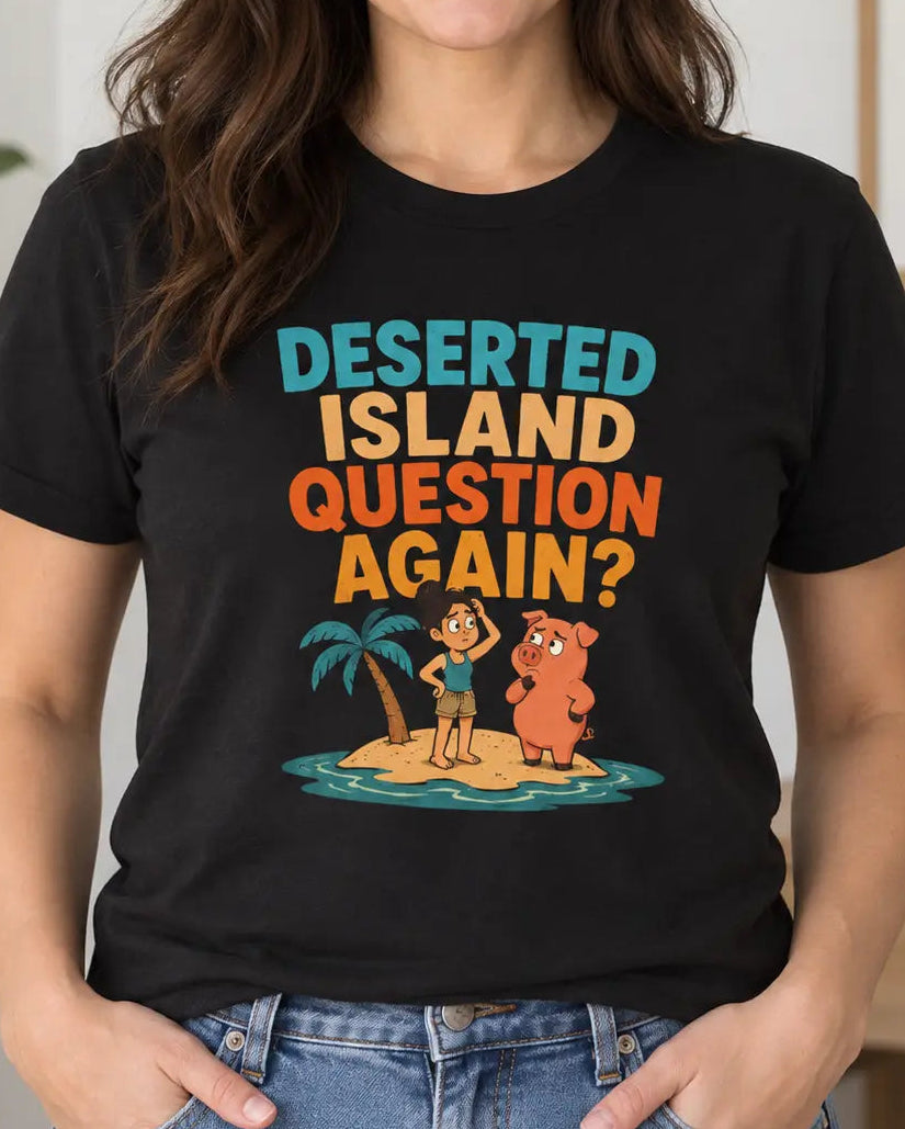 A woman wearing a black graphic t-shirt with the text 'DESERTED ISLAND QUESTION AGAIN?' in colorful letters, standing in a brightly lit room with a plant and framed wall art in the background.