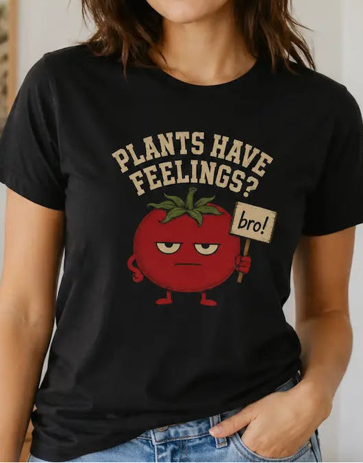woman wearing a Black t-shirt with text "plants have feelings" and a tomato holding a sign 'bro!'