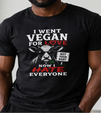Man wearing a black t-shirt with image of a cow holding a sign 'not your baby' and the t-shirt text is 'i went vegan for love now i hate everyone'