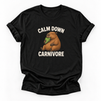 A black short-sleeve crewneck t-shirt featuring a cartoon capybara eating green leaves with the text 'CALM DOWN CARNIVORE' printed in white above and below the graphic, displayed on a clean white background.