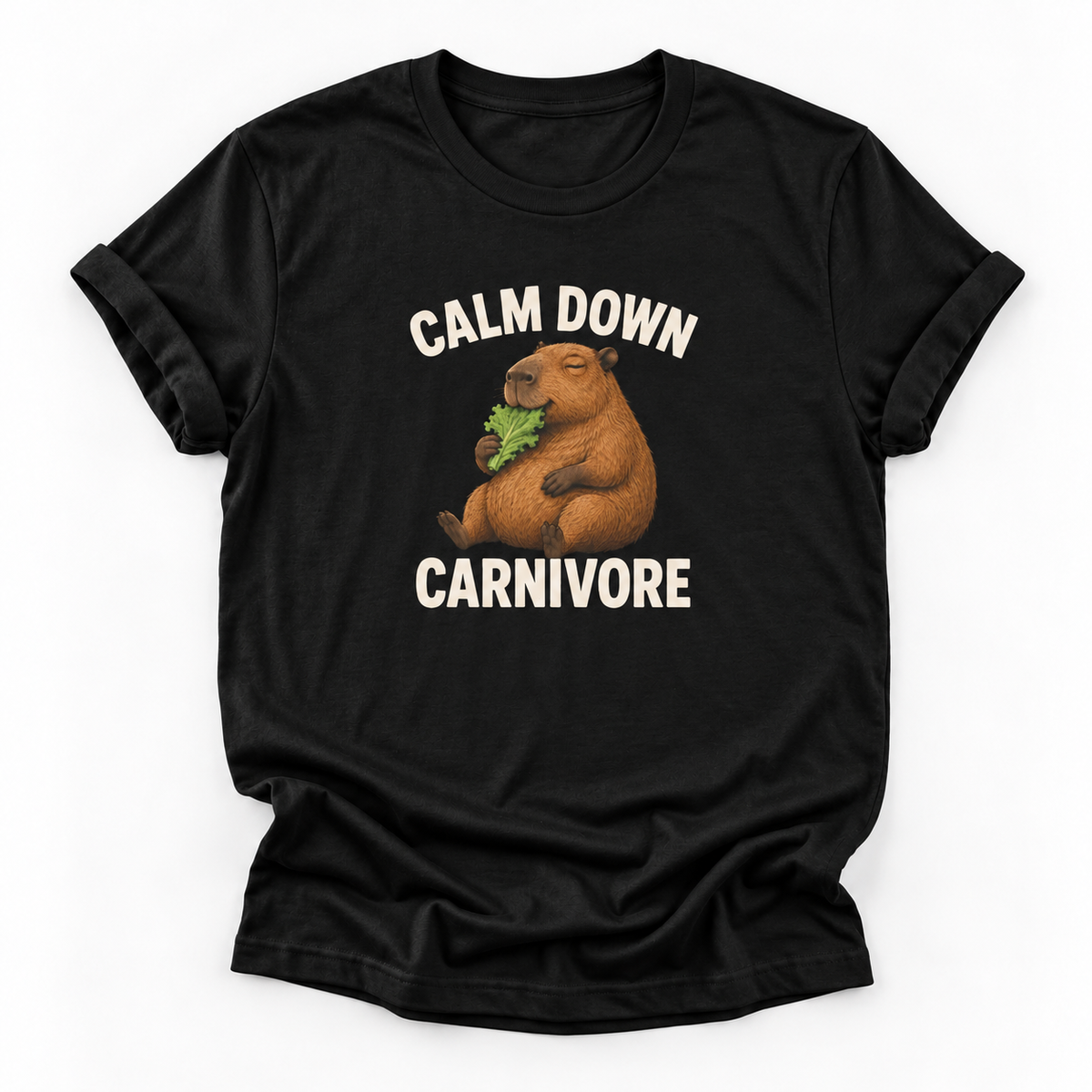 A black short-sleeve crewneck t-shirt featuring a cartoon capybara eating green leaves with the text 'CALM DOWN CARNIVORE' printed in white above and below the graphic, displayed on a clean white background.
