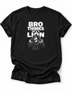 A black short-sleeve vegan crewneck t-shirt with a white graphic print on the front. The text reads 'BRO THINKS HE'S A LION' above an illustration of a man with a beard and sunglasses looking surprised.