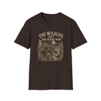Brown t-shirt with nature graphic of animals and halloween characters walking up a path and text 'the wildlife isn;t the scary part