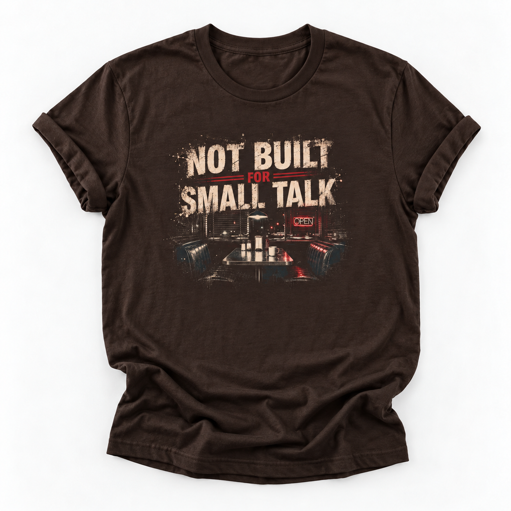 A dark brown short-sleeve t-shirt with a distressed graphic on the front that reads 'NOT BUILT FOR SMALL TALK' above a control room scene, displayed on a clean white background.