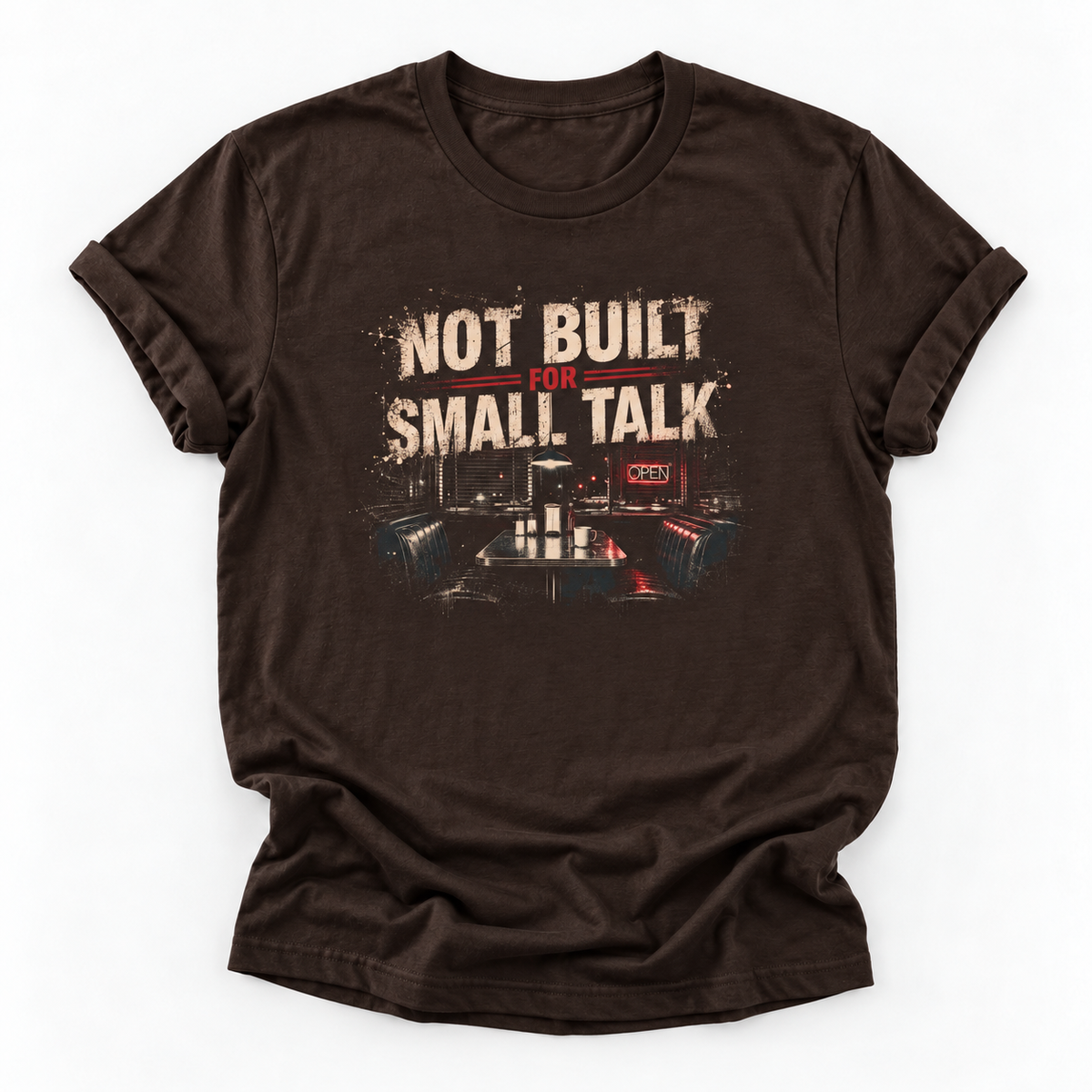 A dark brown short-sleeve t-shirt with a distressed graphic on the front that reads 'NOT BUILT FOR SMALL TALK' above a control room scene, displayed on a clean white background.