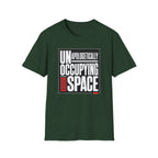 A dark green short-sleeve t-shirt with a graphic print on the front reading 'UNAPOLOGETICALLY OCCUPYING SPACE' in white and red text inside a black rectangular border, shown on a plain white background.