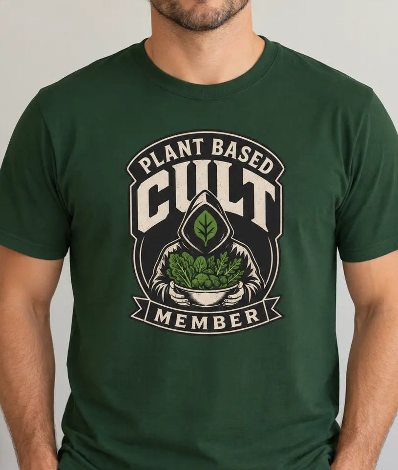 Man wearing a forest green tee with a graphic image and text 'plant based cult member'