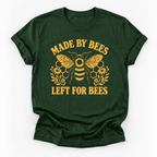 A dark green short-sleeve t-shirt with a yellow graphic print featuring a bee, honeycomb, flowers, and the text 'MADE BY BEES LEFT FOR BEES' on a white background.