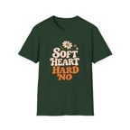 A dark green short-sleeve t-shirt with a retro-style graphic on the chest that reads 'SOFT HEART HARD NO' in cream and orange lettering, accompanied by a small daisy and bee illustration, shown against a plain white background.