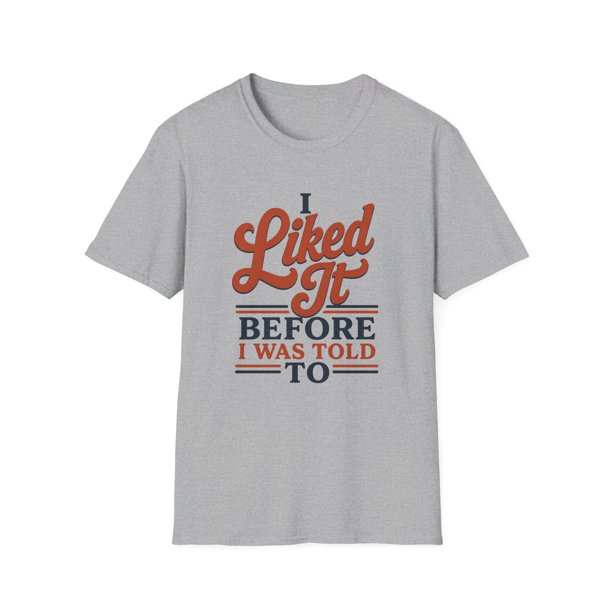 A light heather gray short-sleeve t-shirt with a retro-style graphic on the chest that reads 'I Liked It BEFORE I WAS TOLD TO' in orange and navy blue lettering, shown against a plain white background.