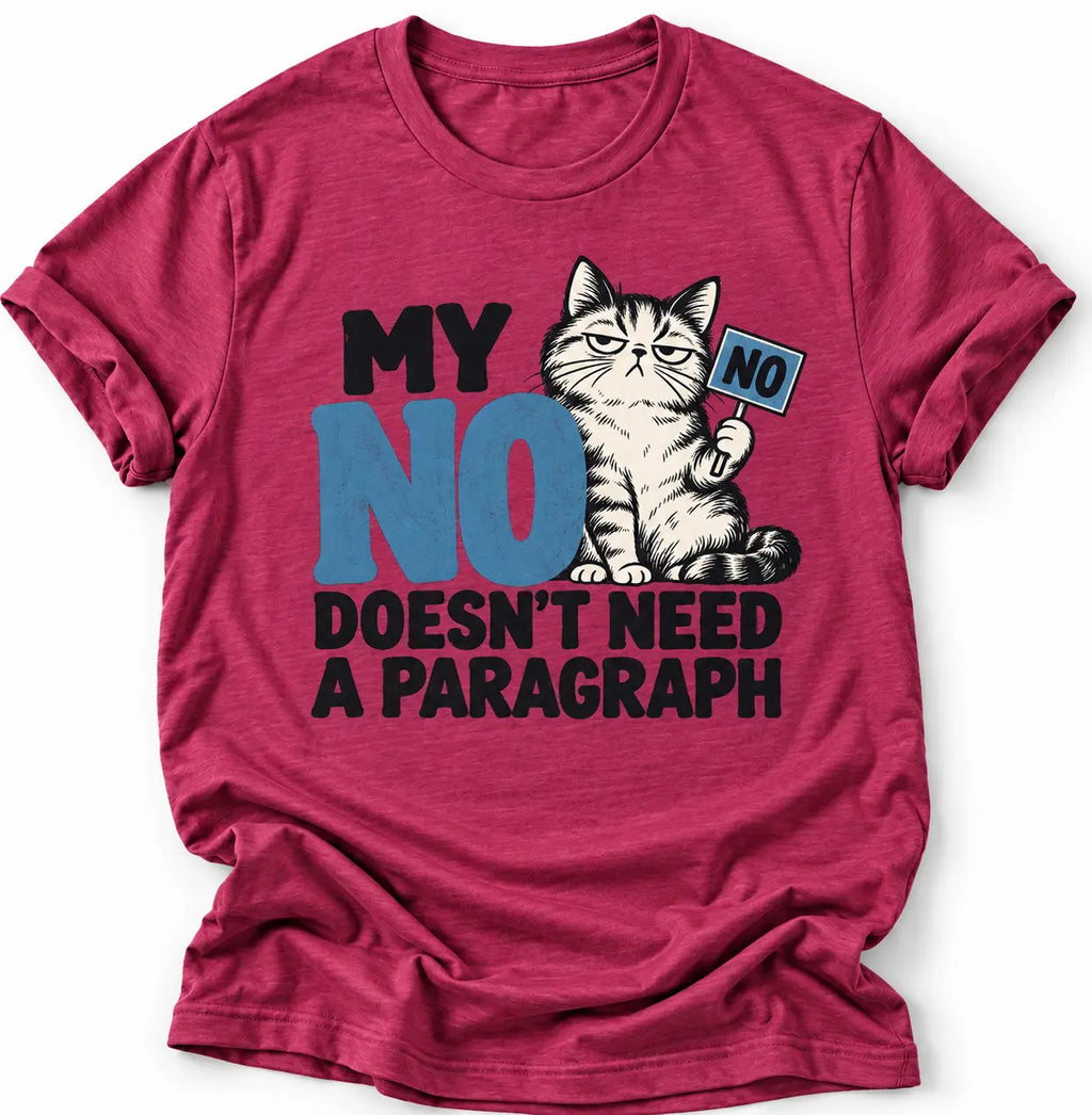 Heather magenta T-shirt with a grumpy cat graphic and the slogan “MY NO DOESN’T NEED A PARAGRAPH” in black and blue lettering. She is wearing blue jeans and photographed against a clean light gray background.