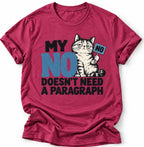 Heather magenta T-shirt with a grumpy cat graphic and the slogan “MY NO DOESN’T NEED A PARAGRAPH” in black and blue lettering. She is wearing blue jeans and photographed against a clean light gray background.
