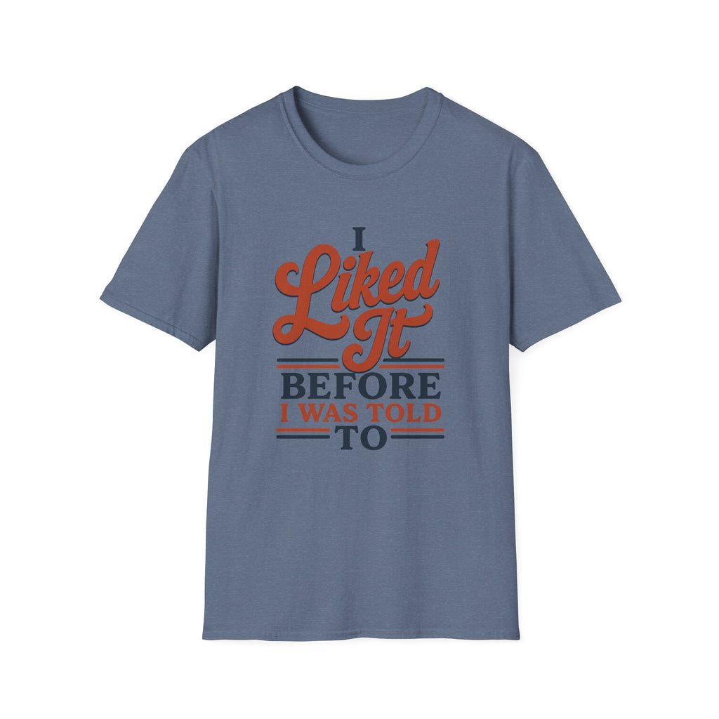 A heathered slate blue short-sleeve t-shirt with a retro-style graphic on the chest that reads 'I Liked It BEFORE I WAS TOLD TO' in orange and navy blue lettering, displayed on a clean white background.