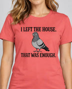 A woman wearing a coral pink t-shirt with a humorous graphic print. The print features the text 'I LEFT THE HOUSE.