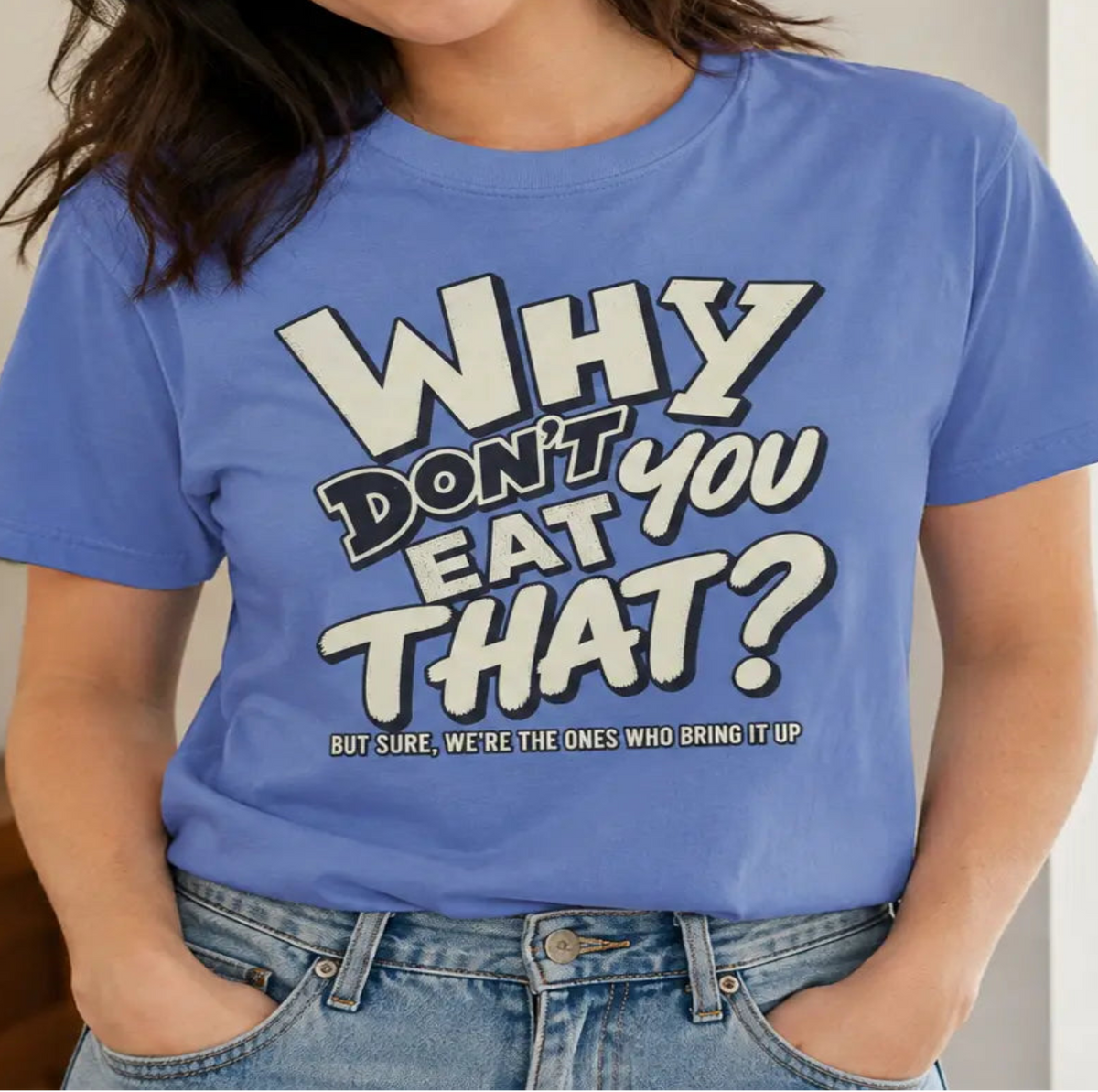 Woman wearing a blue vegan tee with text 'why don't you eat that'