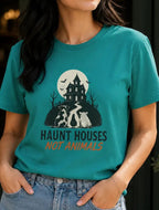 woman wearing a jade green t-shirt with halloween image and the words 'haunt houses not animals'