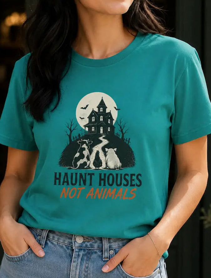 woman wearing a jade green t-shirt with halloween image and the words 'haunt houses not animals'